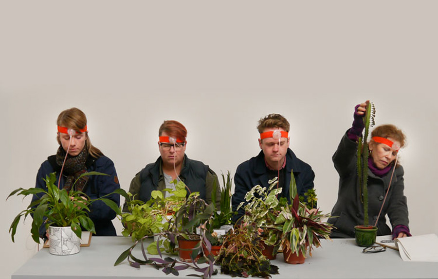 participants wearing special headgear connecting with plants